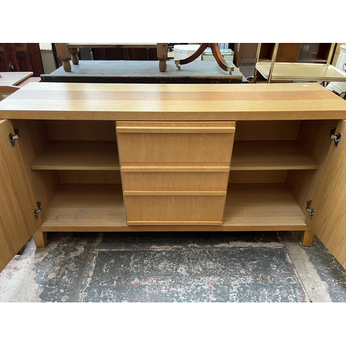 23 - A modern oak sideboard with three central drawers and two outer cupboard doors - approx. 79.5cm high... 