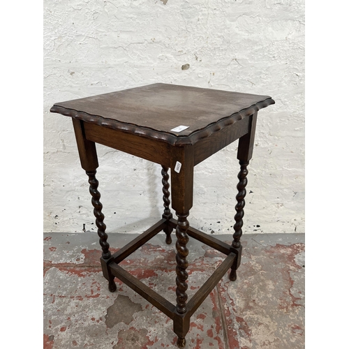 25 - An early 20th century oak pie crust edge side table on barley twist supports