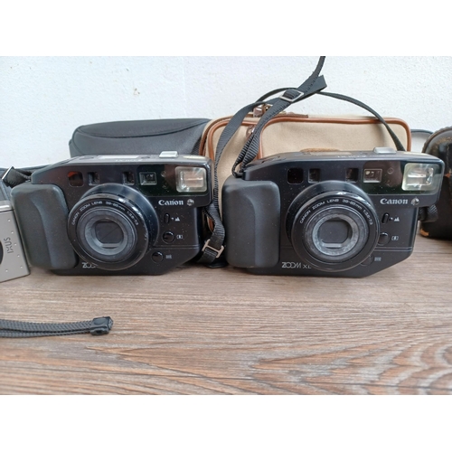 591 - Four cased Canon cameras, one Canonet Junior 35mm viewfinder, one IXUS for APS film and two Sure Sho... 