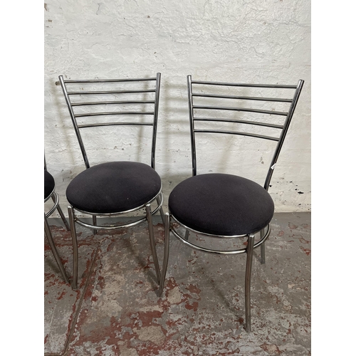 29 - A set of four tubular metal and grey fabric upholstered dining chairs