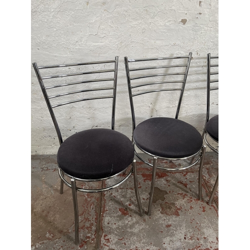 29 - A set of four tubular metal and grey fabric upholstered dining chairs