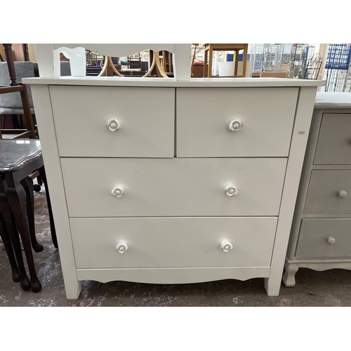 31 - A modern white painted chest of two short over two long drawers and matching side table