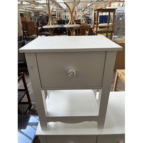 31 - A modern white painted chest of two short over two long drawers and matching side table