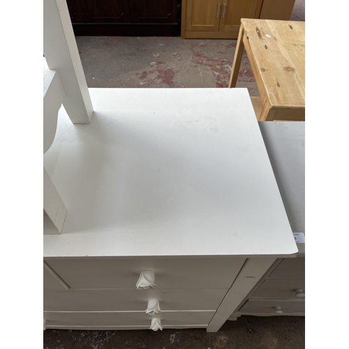 31 - A modern white painted chest of two short over two long drawers and matching side table