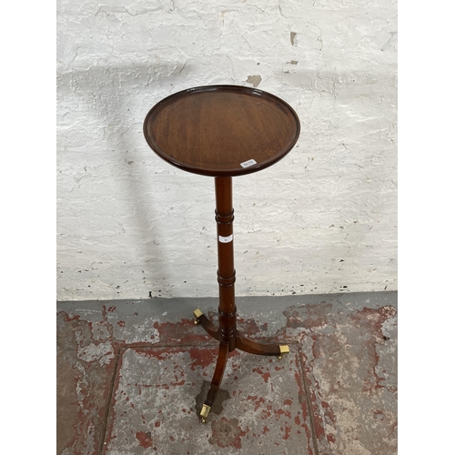 43 - A Regency style mahogany jardinière stand with tripod pedestal support, brass castors and circular t... 