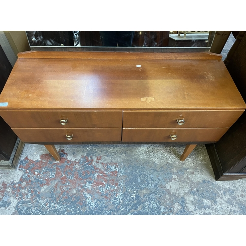 46 - A mid 20th century teak dressing table with four drawers and upper mirror