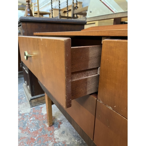 46 - A mid 20th century teak dressing table with four drawers and upper mirror