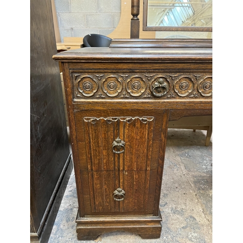 48 - A Crown Ay carved oak dressing table with four linenfold drawers and two upper drawers