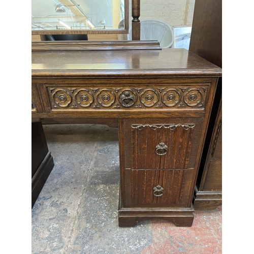 48 - A Crown Ay carved oak dressing table with four linenfold drawers and two upper drawers