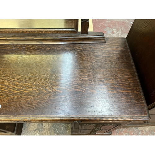 48 - A Crown Ay carved oak dressing table with four linenfold drawers and two upper drawers