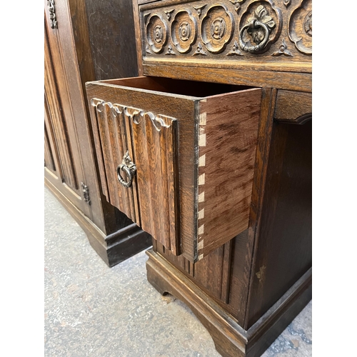 48 - A Crown Ay carved oak dressing table with four linenfold drawers and two upper drawers