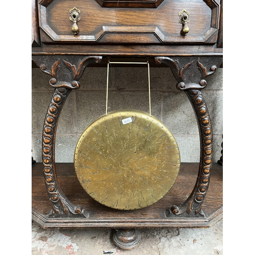 5 - A Victorian geometric carved oak hall table with galleried back, barley twist supports and brass gon... 