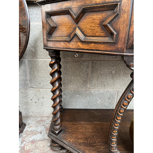 5 - A Victorian geometric carved oak hall table with galleried back, barley twist supports and brass gon... 