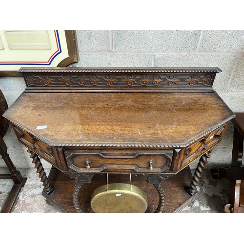 5 - A Victorian geometric carved oak hall table with galleried back, barley twist supports and brass gon... 