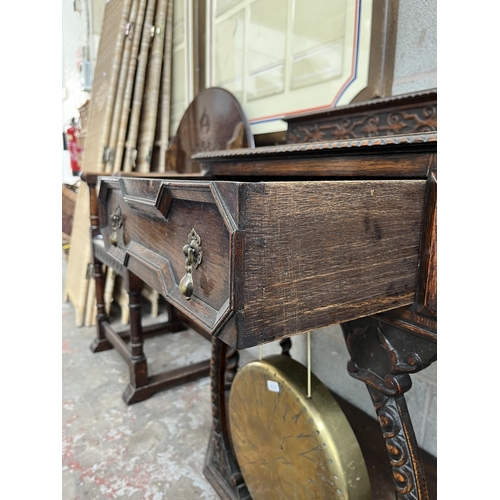 5 - A Victorian geometric carved oak hall table with galleried back, barley twist supports and brass gon... 