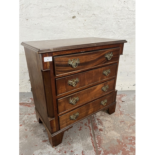 50 - A Georgian style mahogany chest of four drawers with brass handles and bracket supports