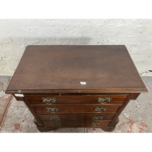 50 - A Georgian style mahogany chest of four drawers with brass handles and bracket supports