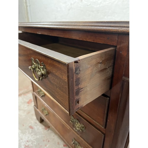 50 - A Georgian style mahogany chest of four drawers with brass handles and bracket supports