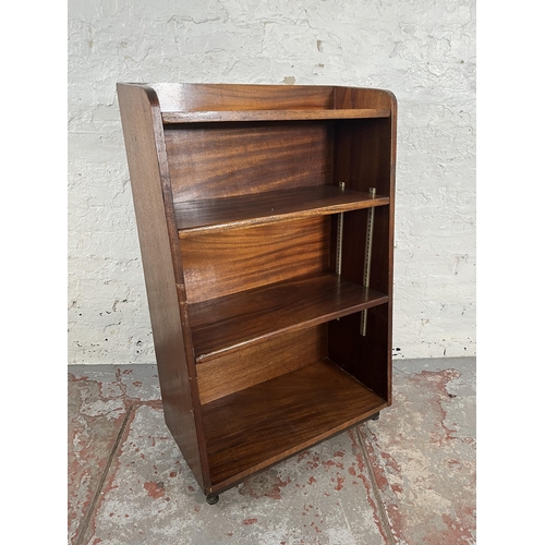 51 - A mid 20th century mahogany four tier bookcase on castors