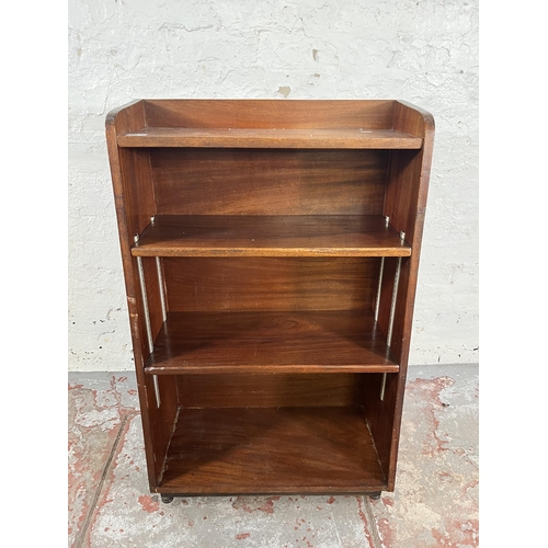 51 - A mid 20th century mahogany four tier bookcase on castors