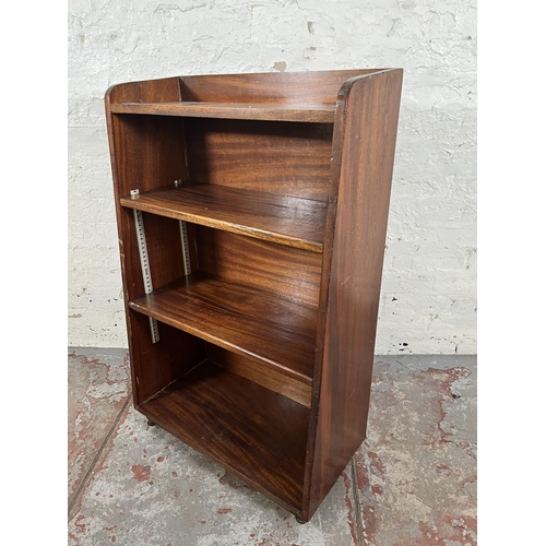 51 - A mid 20th century mahogany four tier bookcase on castors