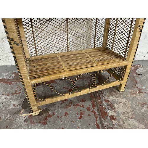 54 - A mid 20th century wicker three tier open bookcase