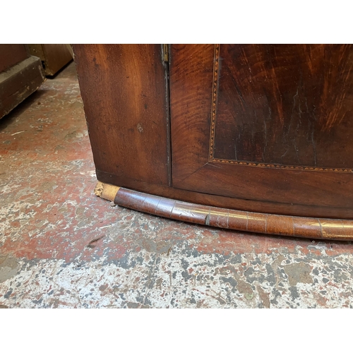 56 - A Georgian inlaid mahogany bow front wall mountable corner cabinet