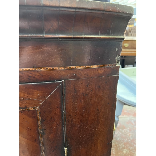 56 - A Georgian inlaid mahogany bow front wall mountable corner cabinet