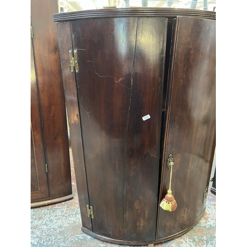 57 - A Georgian mahogany bow front wall mountable corner cabinet