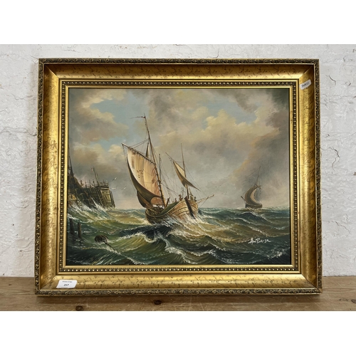 217 - A gilt framed oil on canvas of sailing ships, signed Ambrose - approx. 51cm high x 61cm wide