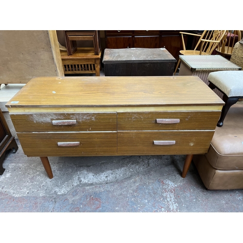 112 - A teak effect dressing table with four drawers and upper mirror