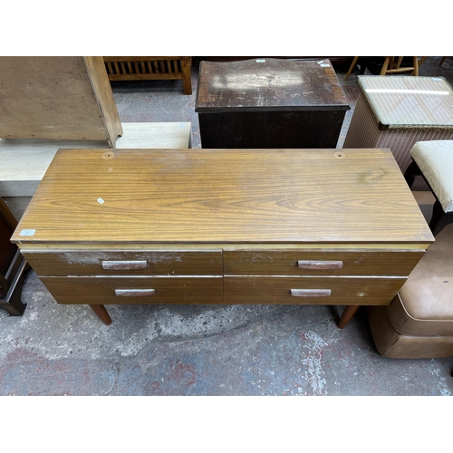 112 - A teak effect dressing table with four drawers and upper mirror