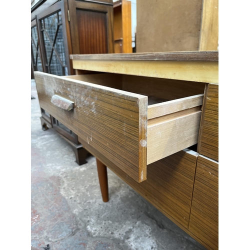 112 - A teak effect dressing table with four drawers and upper mirror