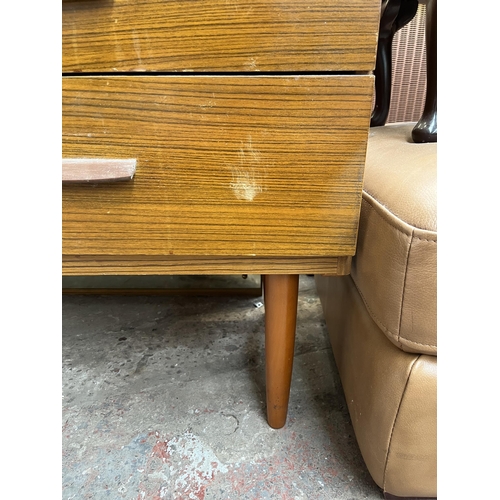 112 - A teak effect dressing table with four drawers and upper mirror