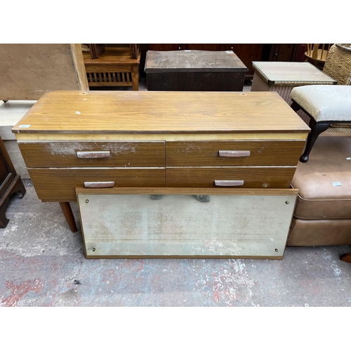 112 - A teak effect dressing table with four drawers and upper mirror