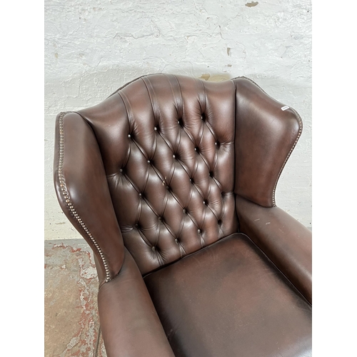 133 - A brown leather Chesterfield wing back armchair