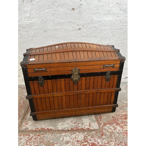 138 - A vintage wooden dome top travel trunk with fitted interior