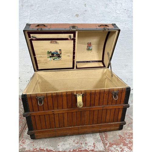 138 - A vintage wooden dome top travel trunk with fitted interior