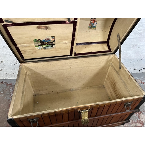 138 - A vintage wooden dome top travel trunk with fitted interior