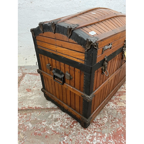 138 - A vintage wooden dome top travel trunk with fitted interior