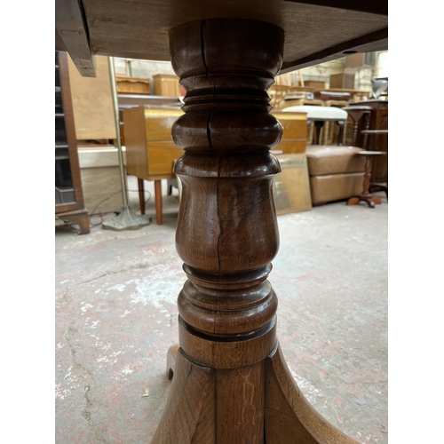 140 - A Georgian oak circular tilt top occasional table on tripod pedestal support