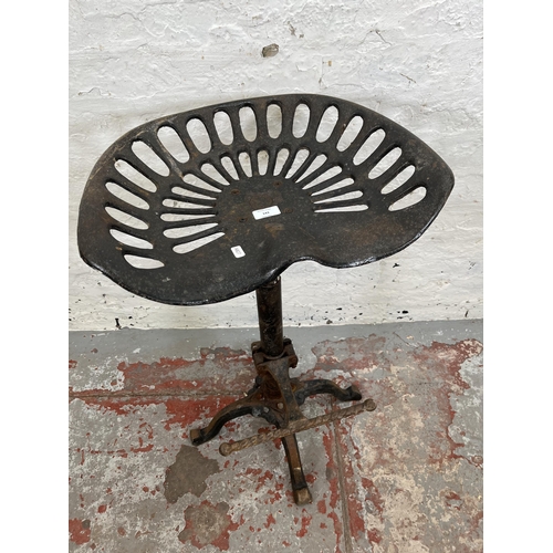 143 - A cast iron tractor seat stool