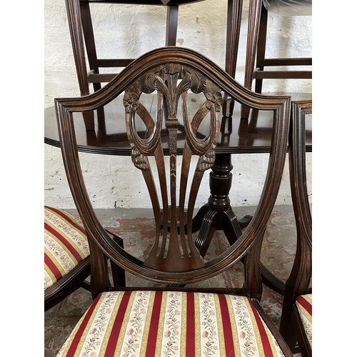 152 - A Georgian style mahogany drop leaf oval dining table and six Hepplewhite style dining chairs