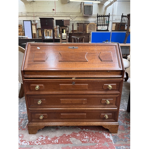 155 - A mahogany bureau with three drawers and fall front