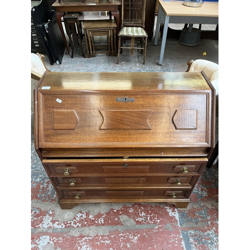 155 - A mahogany bureau with three drawers and fall front