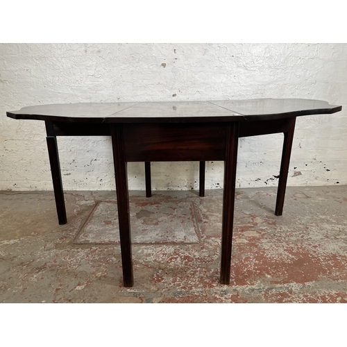 157 - A George II mahogany drop leaf gate leg serpentine dining table