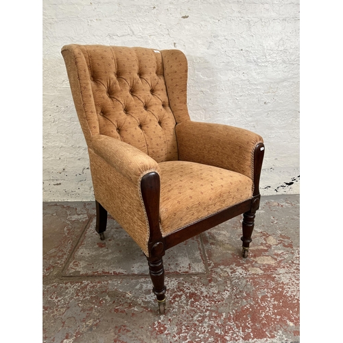 161 - A late 19th/early 20th century mahogany and fabric upholstered wing back armchair