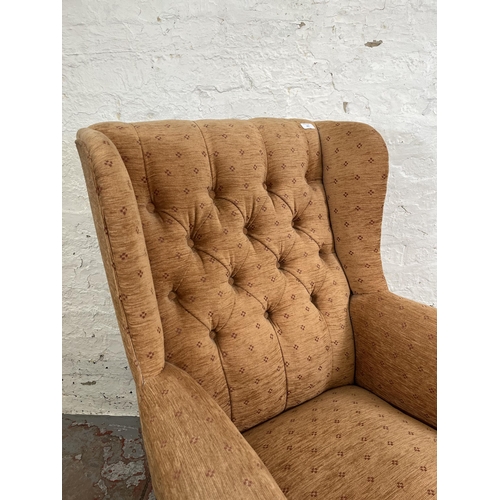 161 - A late 19th/early 20th century mahogany and fabric upholstered wing back armchair