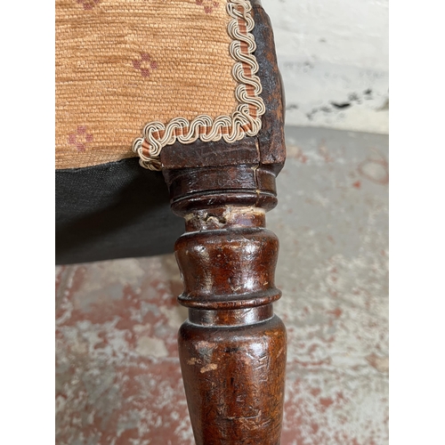 161 - A late 19th/early 20th century mahogany and fabric upholstered wing back armchair