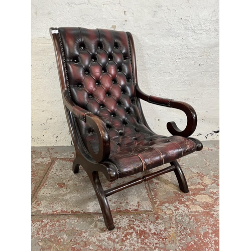 164 - A mahogany and oxblood leather Chesterfield slipper chair